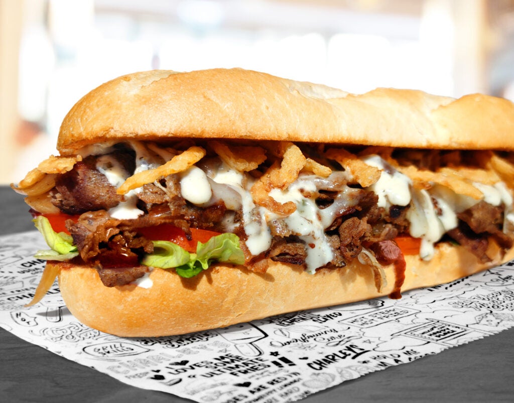 The Parmesan Peppercorn Cheesetseak from Charleys Cheesesteaks and Wings, loaded with grilled steak, A.1.® Sauce, Provolone Cheese Crispy Onions, Sautéed Onions, Lettuce and Tomato.
